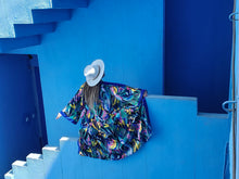 Load image into Gallery viewer, KIMONO WITH FLOWERS AND LEAVES ,COLORFUL PERFECT FOR SUMMER DAYS OR FOR PARTIES, medium lenght shot in Muralla Roja, Spain styled with hat
