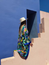 Load image into Gallery viewer, KIMONO WITH FLOWERS AND LEAVES ,COLORFUL PERFECT FOR SUMMER DAYS OR FOR PARTIES, medium lenght shot in Muralla Roja, Spain styled with hat
