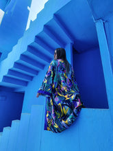 Load image into Gallery viewer, KIMONO WITH FLOWERS AND LEAVES ,COLORFUL PERFECT FOR SUMMER DAYS OR FOR PARTIES, medium lenght shot in Muralla Roja, Spain
