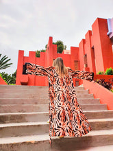 Load image into Gallery viewer, KIMONO ANIMAL PRINT, TIGER PRINT, GIRL WEARING KIMOIO IN AN IDYLLIC SET IN MURALLA ROJA SPAIN, KIMONO MADE OF SUSTAINABLE FABRICS, ETHICAL WORK
